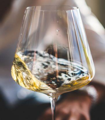 A swirling wine glass of white wine